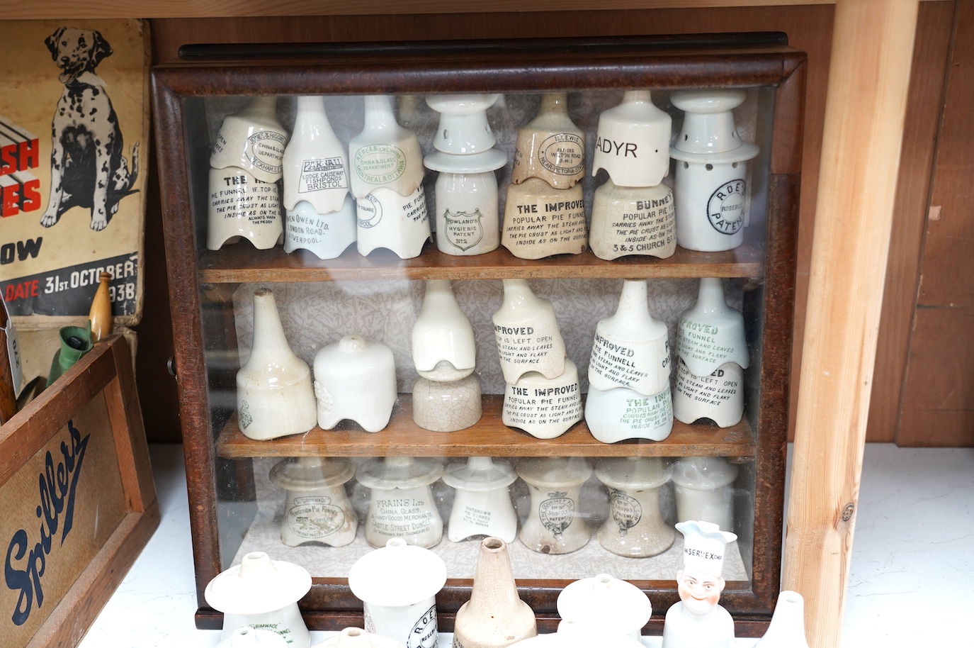 Approximately fifty assorted Victorian pottery pie funnels, some contained within a mahogany display case. Condition - varies
